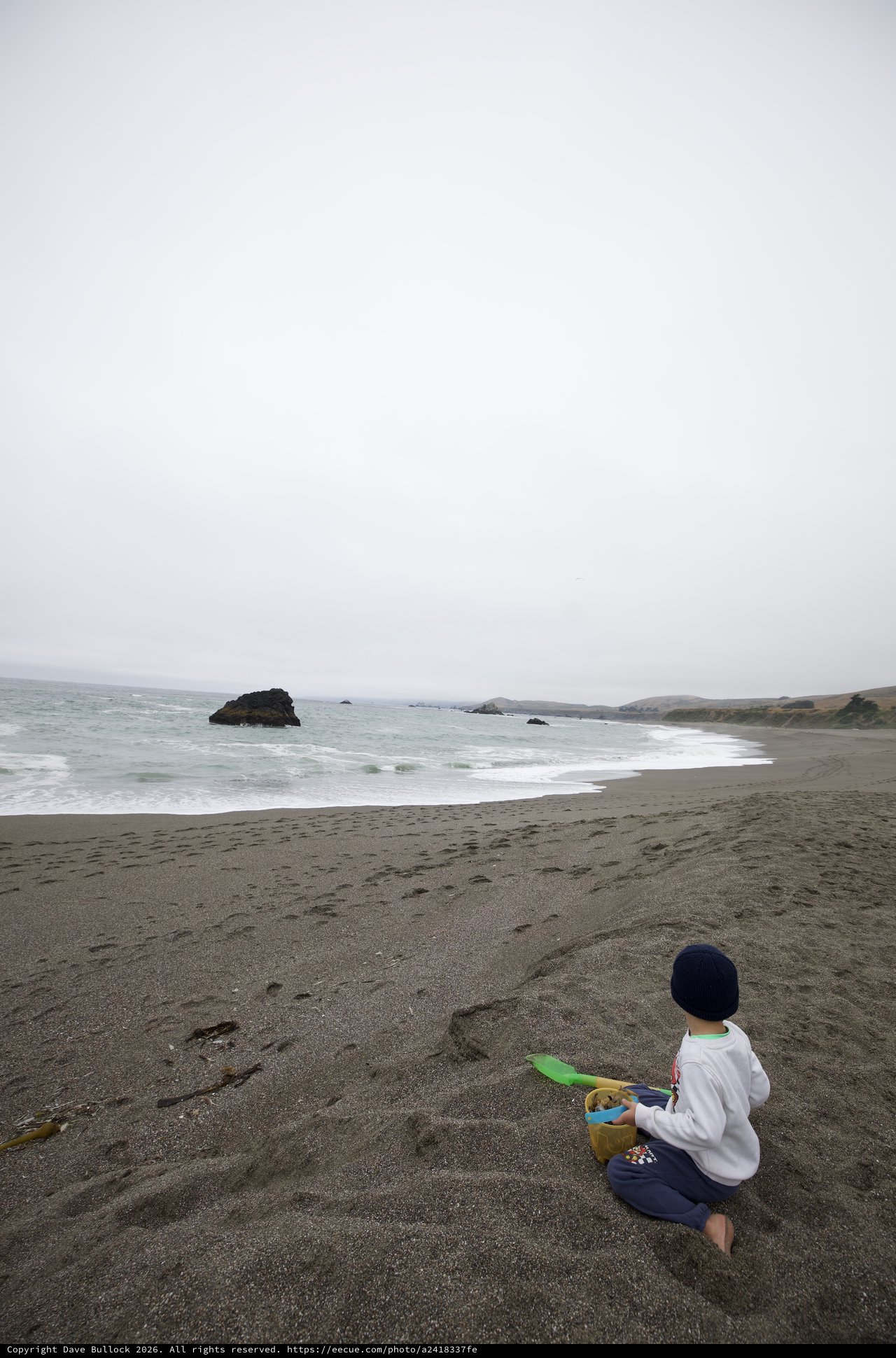 Child Playing in Sand at Foggy Northern California Beach