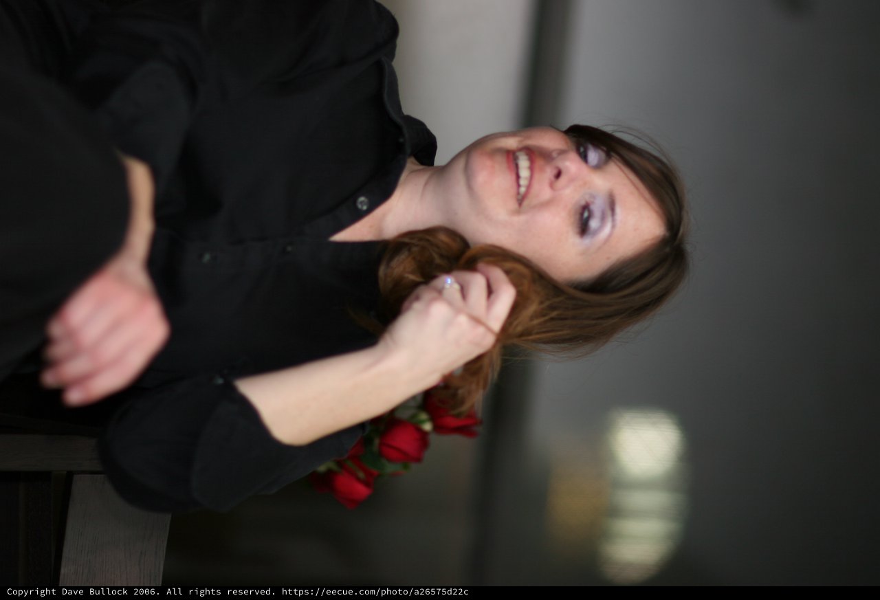 Woman with Smeared Makeup Laughing Among Red Roses