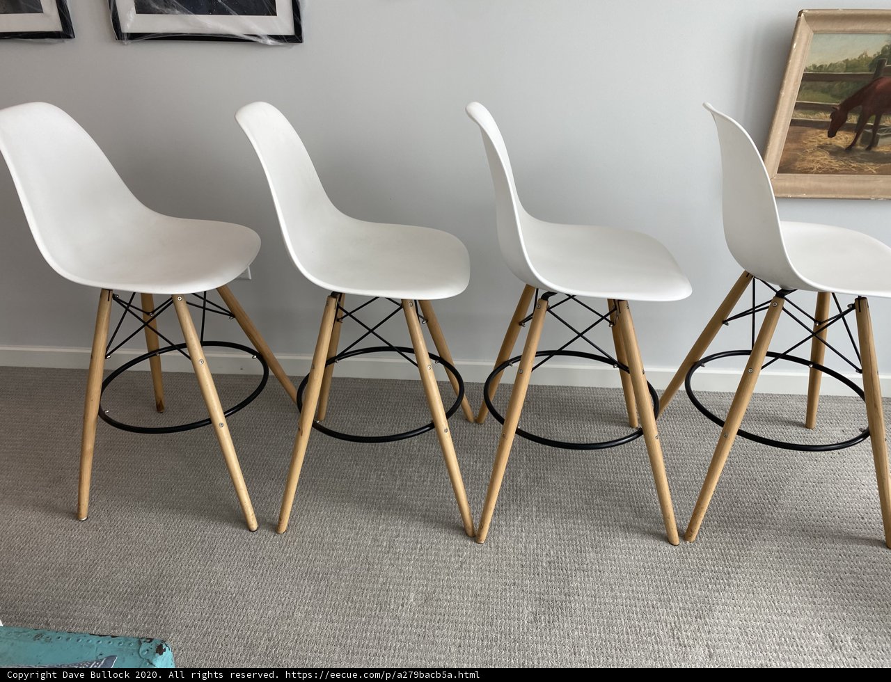 White Bar Stools with Wooden Legs in a Chic Interior Setting