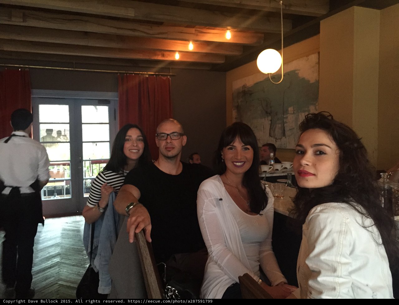 Friends Gathering at a Stylish Urban Restaurant