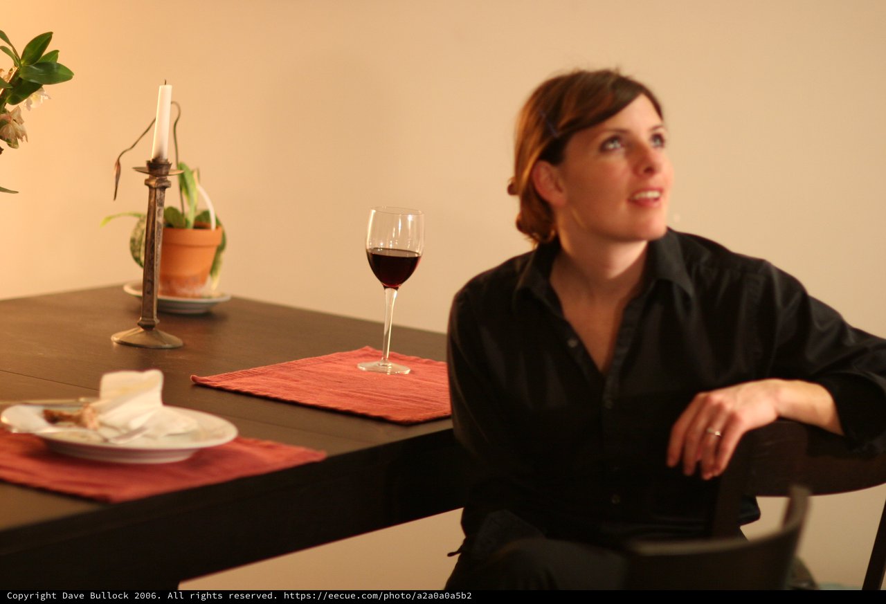 Woman in Black Contemplating Over Evening Wine