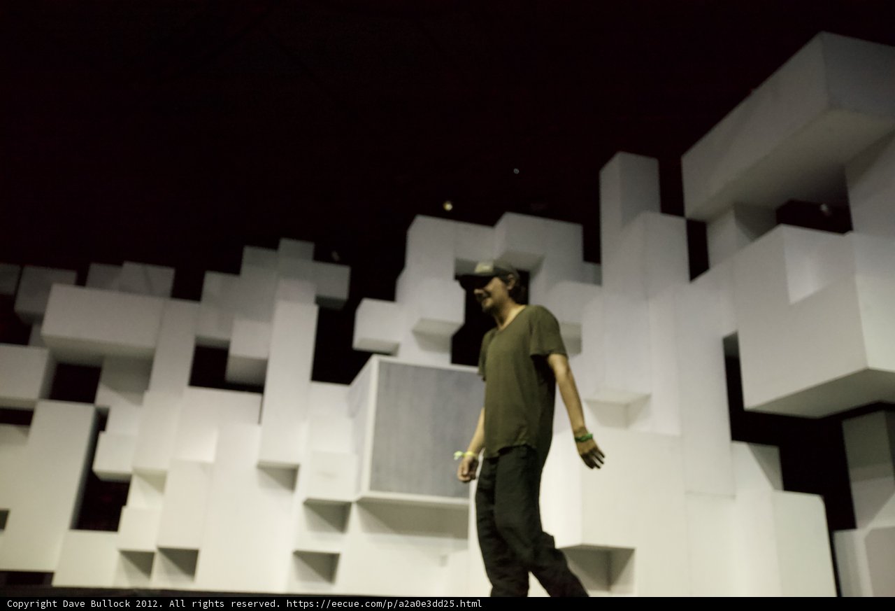 Man in Hat Dancing on White Cube Stage