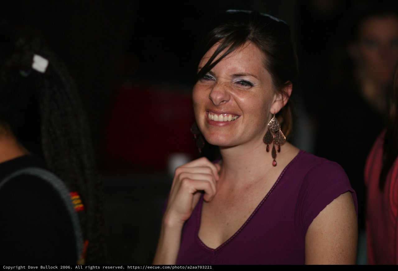 Radiant Smile at a Nighttime Social Gathering