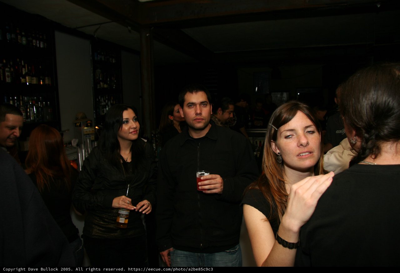 Friends Socializing at a Dimly Lit Bar Night