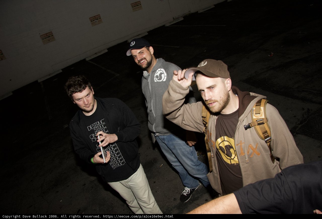 Three Men Hanging Out in a Parking Lot