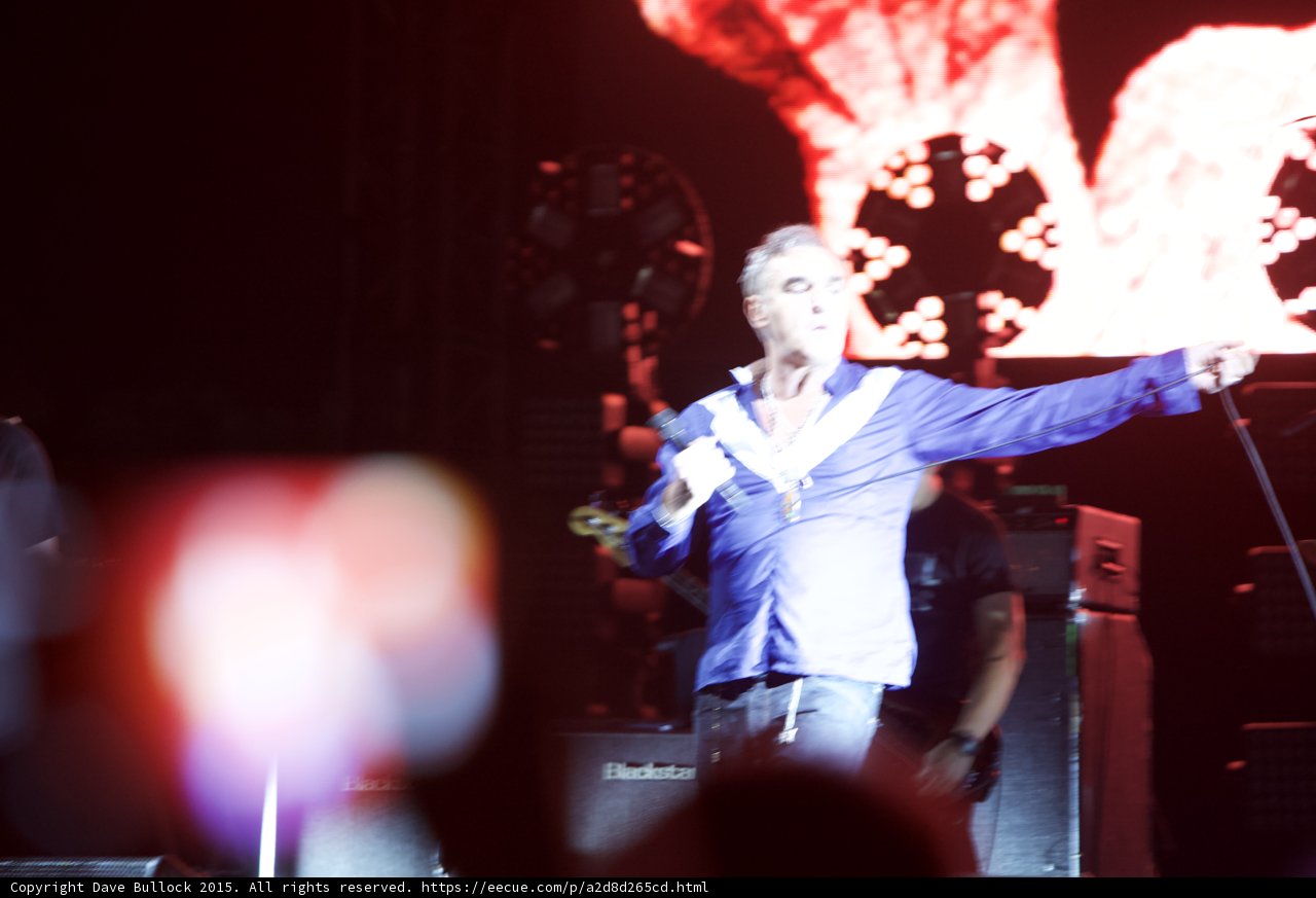 Morrissey Motion Blur Arm Outstretched Blue Shirt Bassist Circular Lights Blackstar Red Screen Phone
