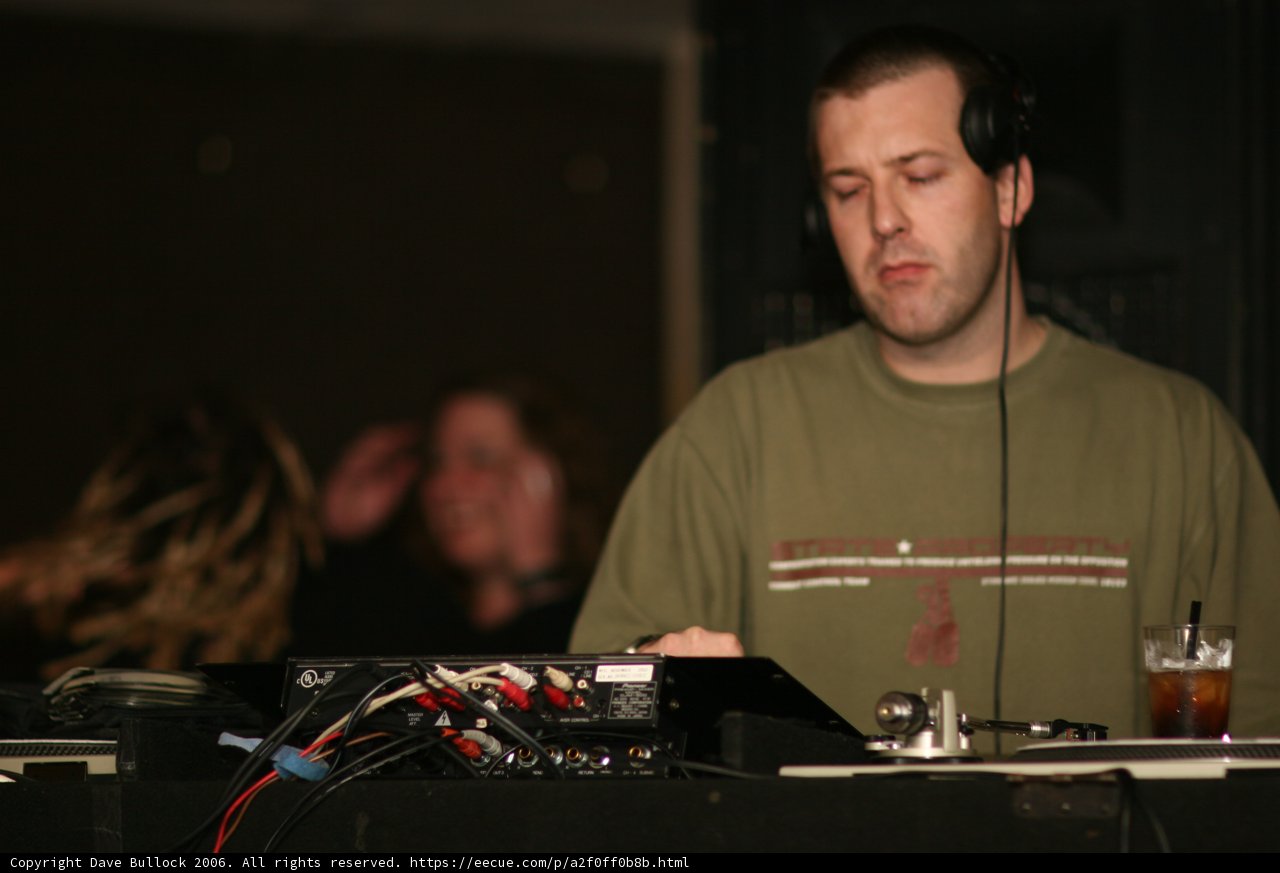 Green Shirted DJ Spinning the Hits