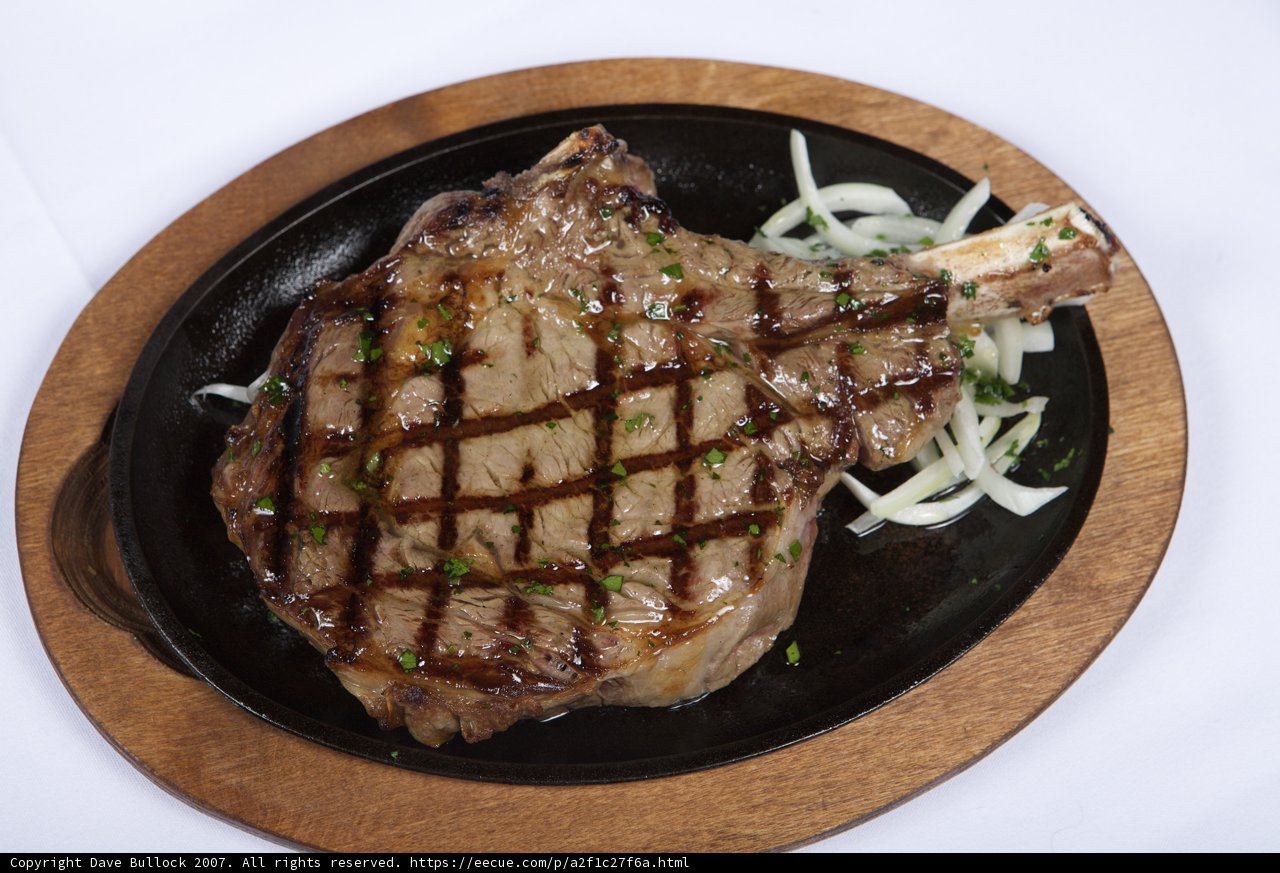 Juicy Steak and Sautéed Onions on a Black Plate