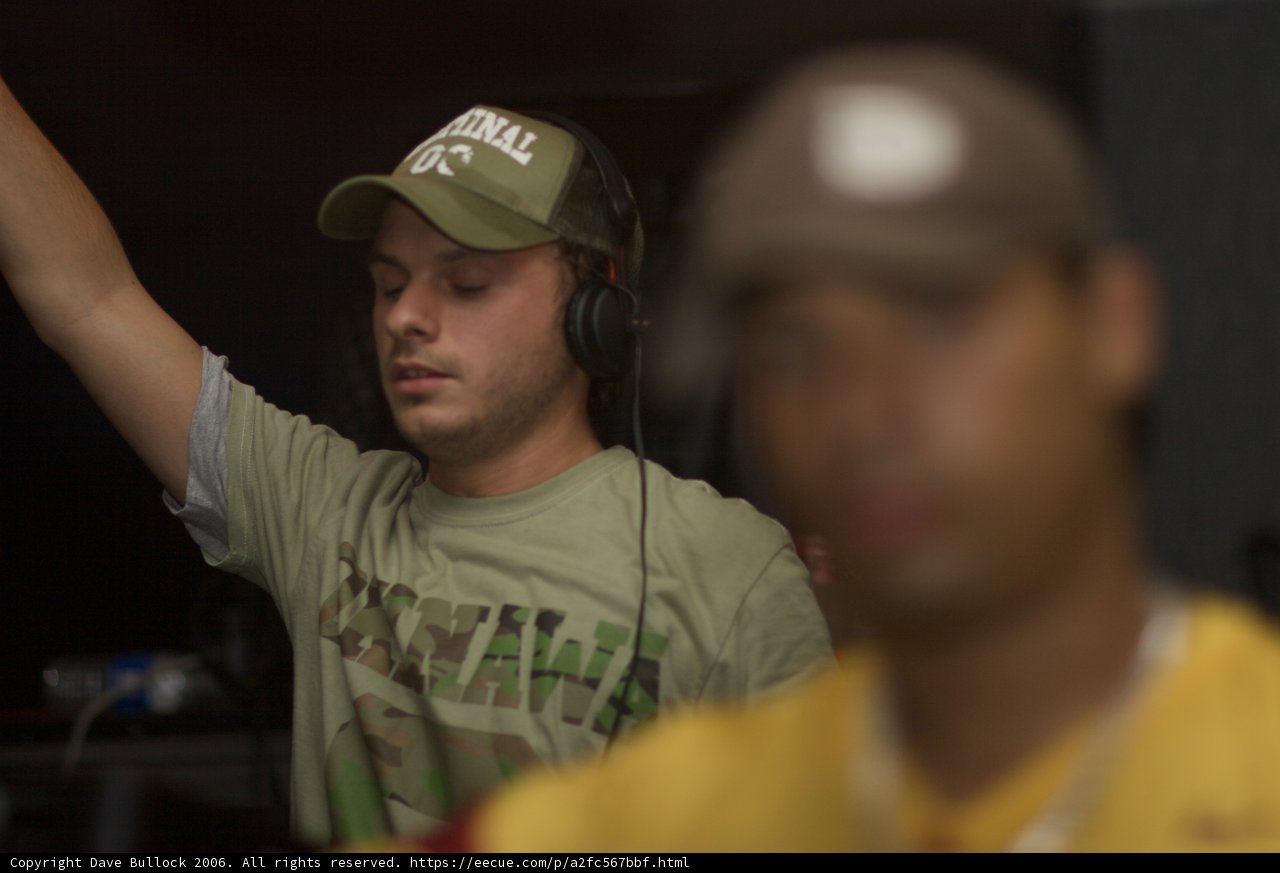Andy C sporting a bright yellow shirt and baseball cap