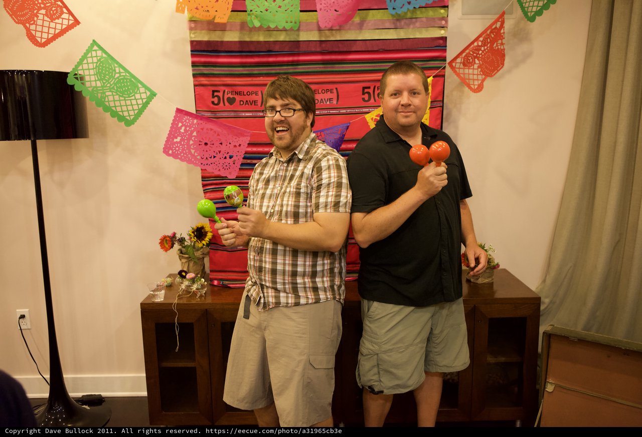 Two Friends Celebrate with Maracas at Fiesta Party