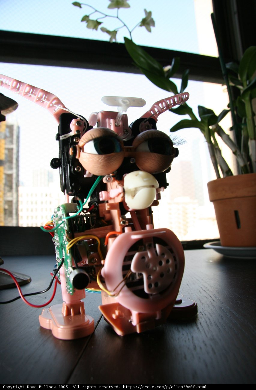 Pink-Eyed Robot Surrounded by Plants