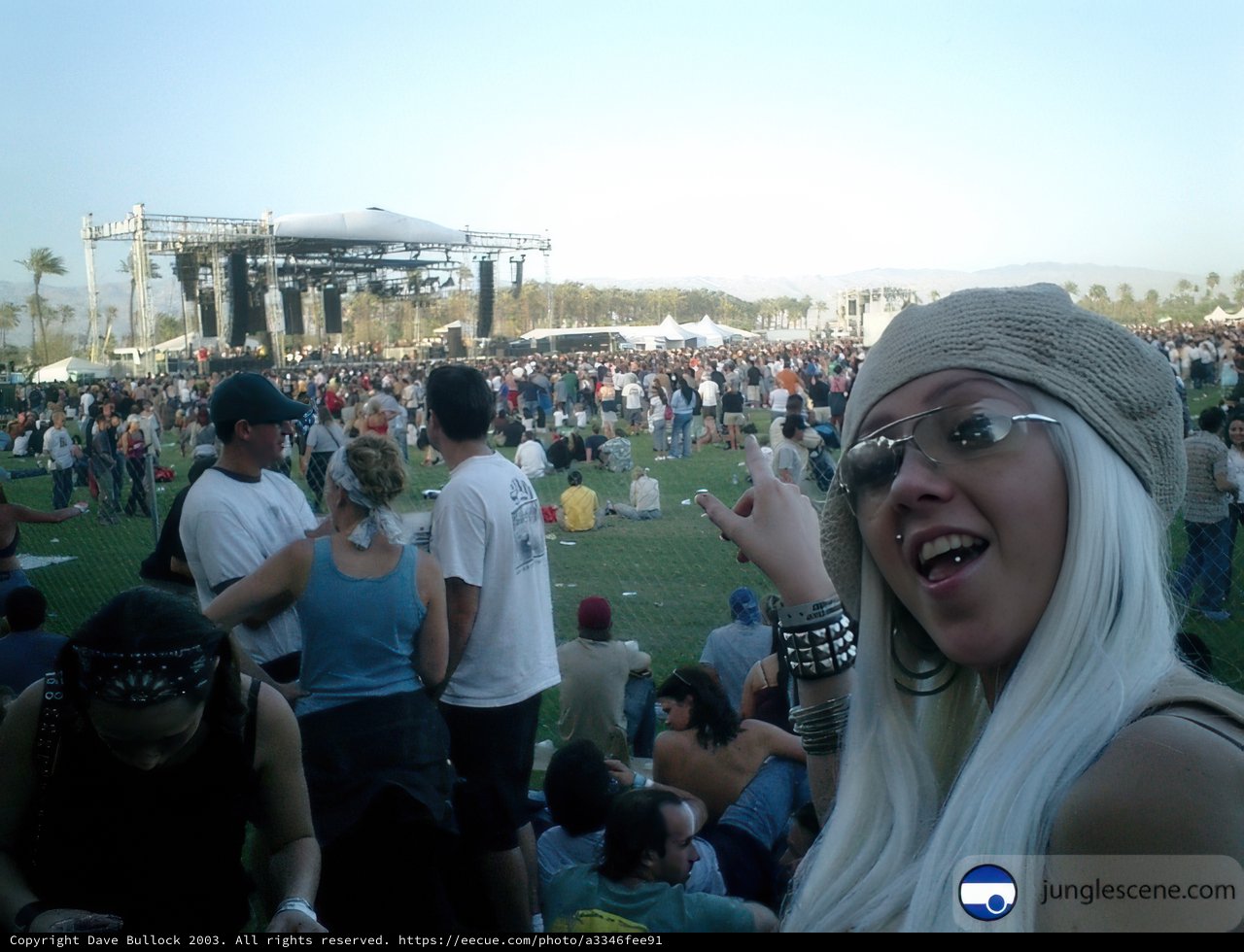 Woman with White Hair and Glasses in Front of a Crowd at Coachella