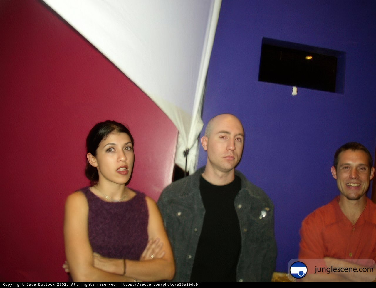 Three People In Front of a Purple Wall