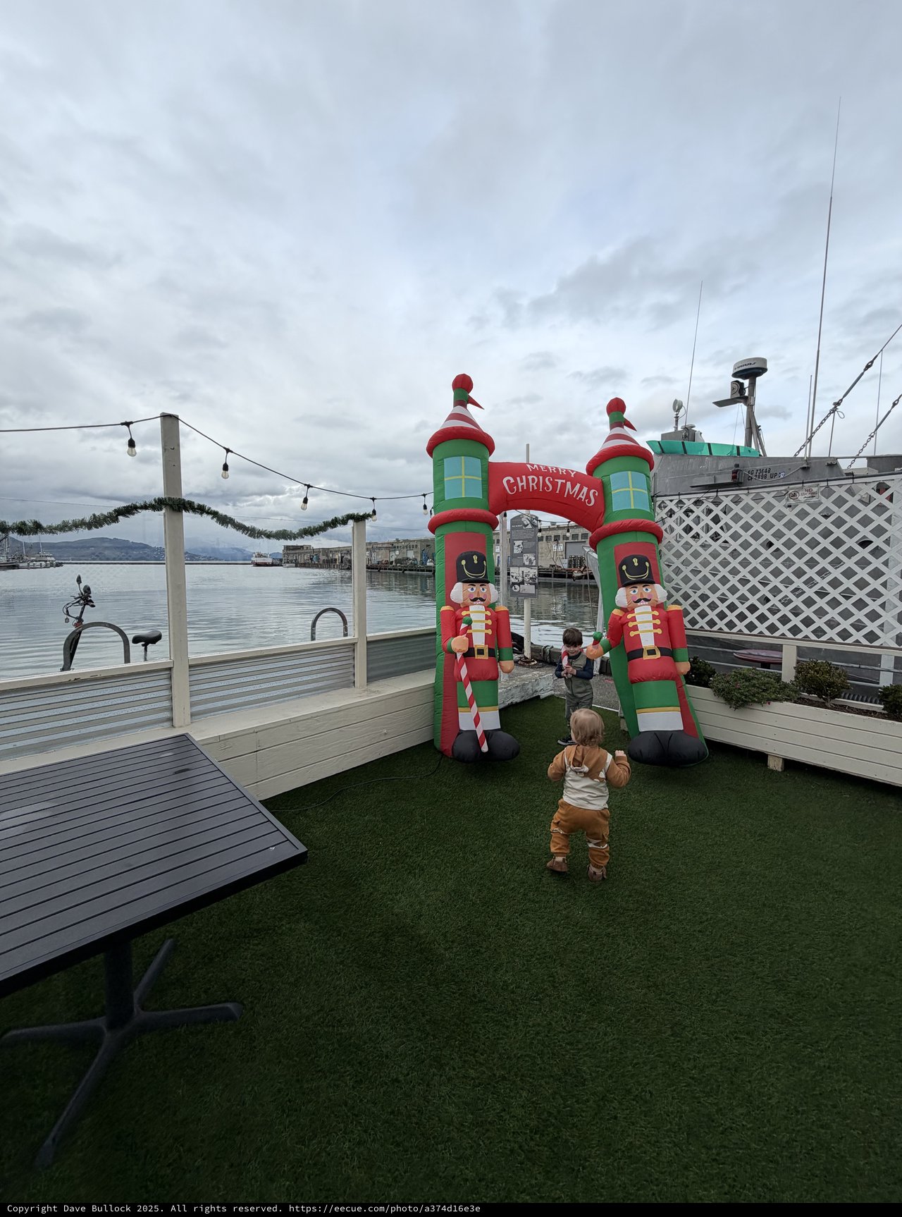 Toddler at Waterfront Christmas Display on Cloudy Day