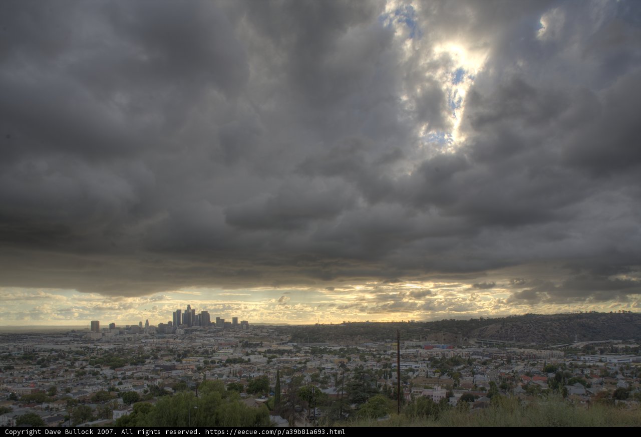 Urban Skyline Amidst Cumulus Clouds