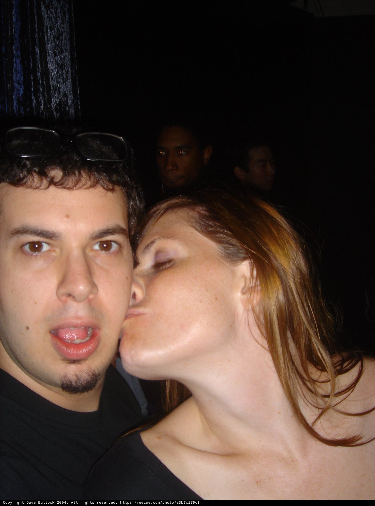 Spontaneous Kiss at a Crowded Nightclub Party