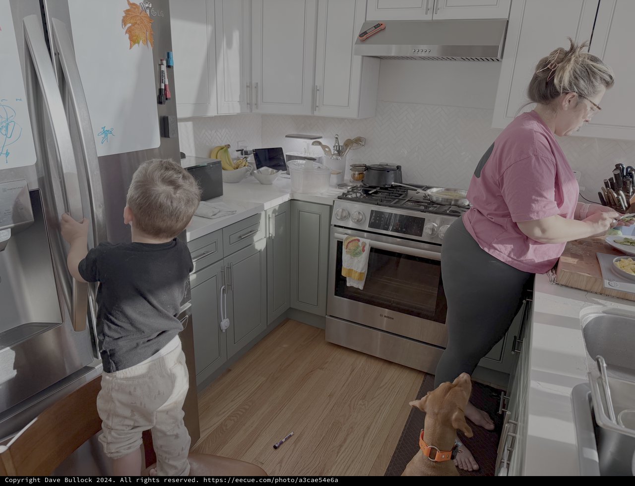 Mother and Child Cooking Together in Kitchen