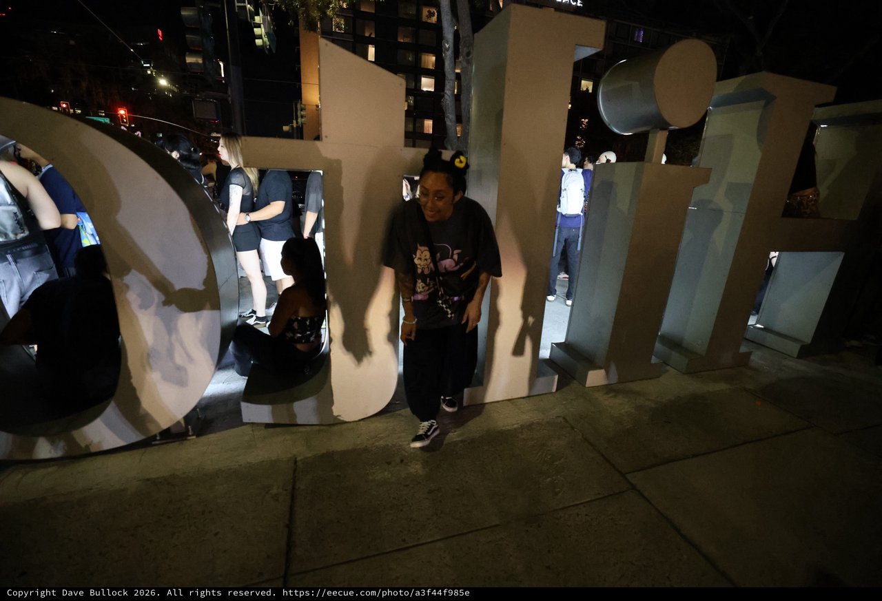 Night Revelers Pose Among Giant Festival Letters