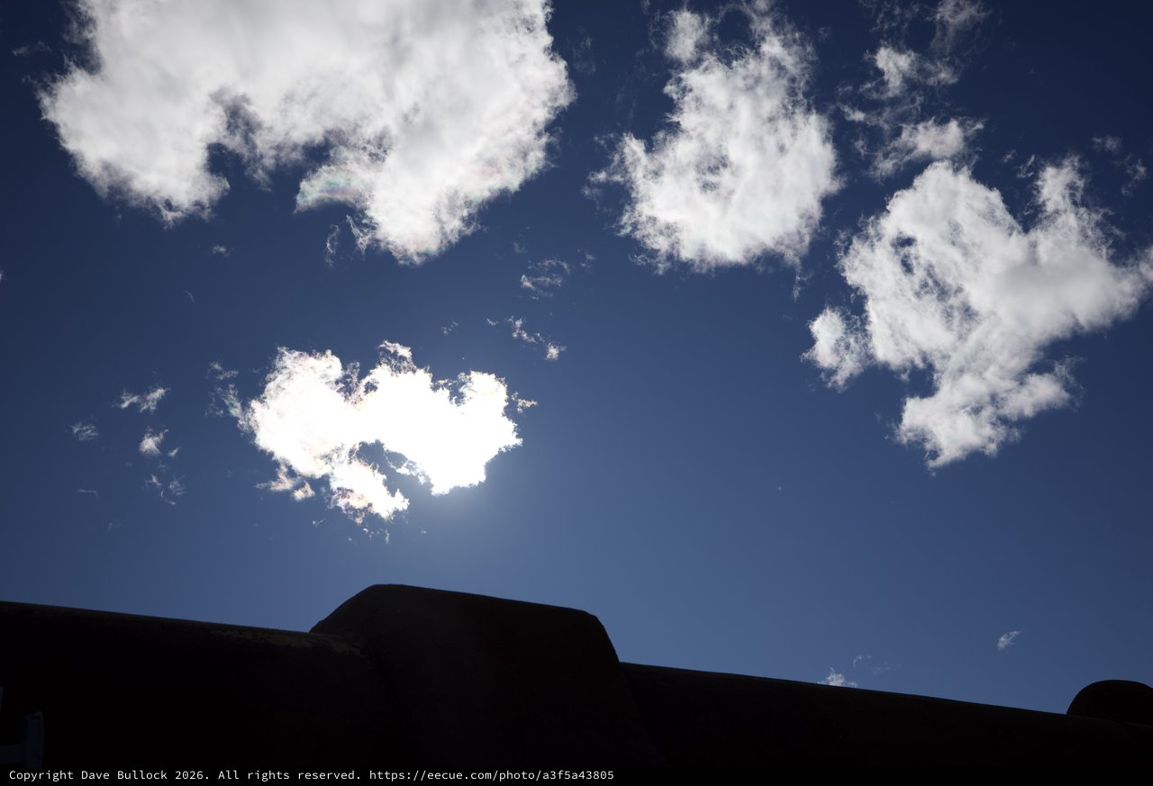 Silhouetted Adobe Architecture Against Bright Blue Sky