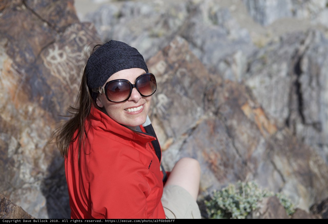Smiling Hiker Pauses Among Desert Rocky Terrain