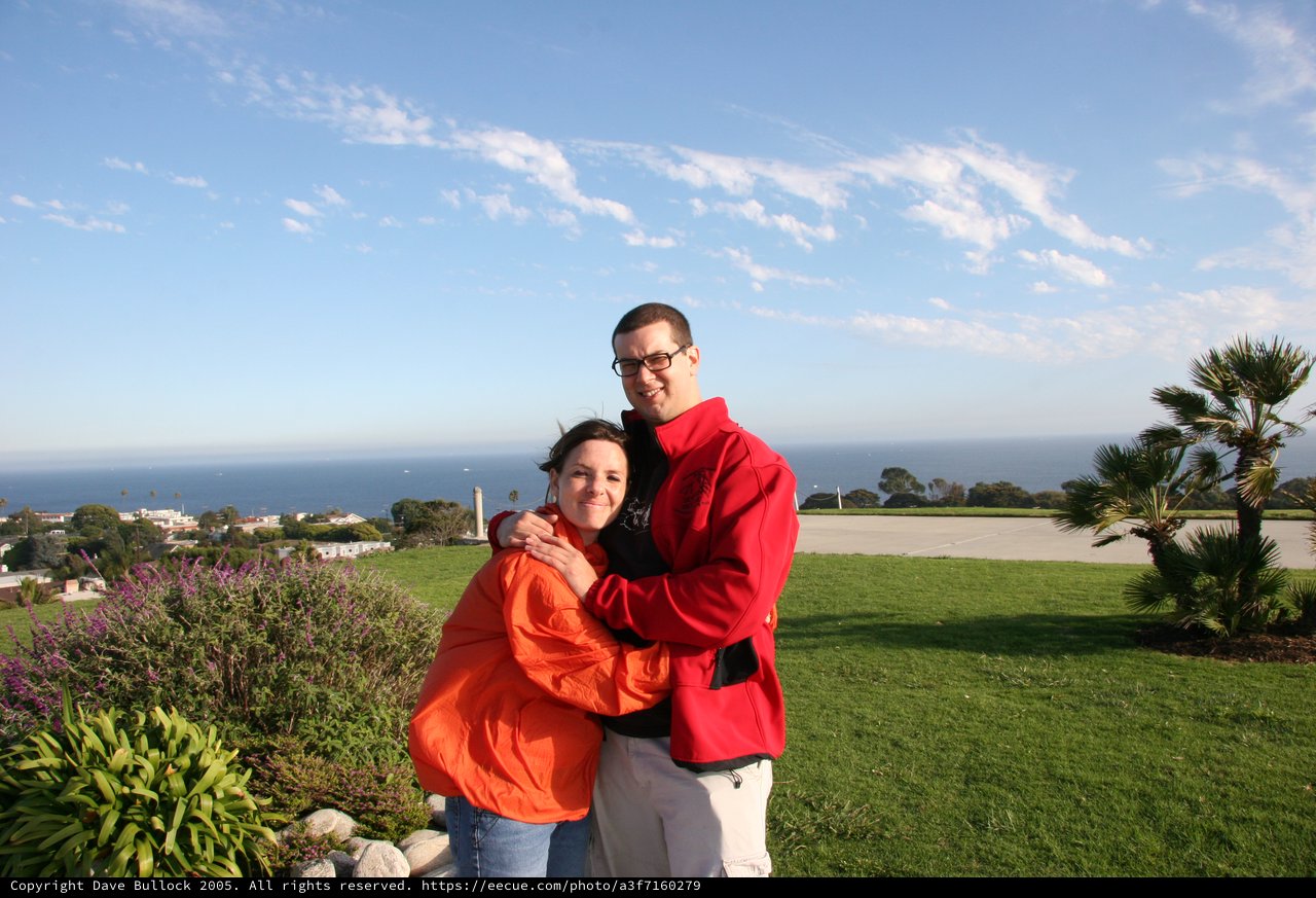 Couple Embracing with Ocean View Behind Them