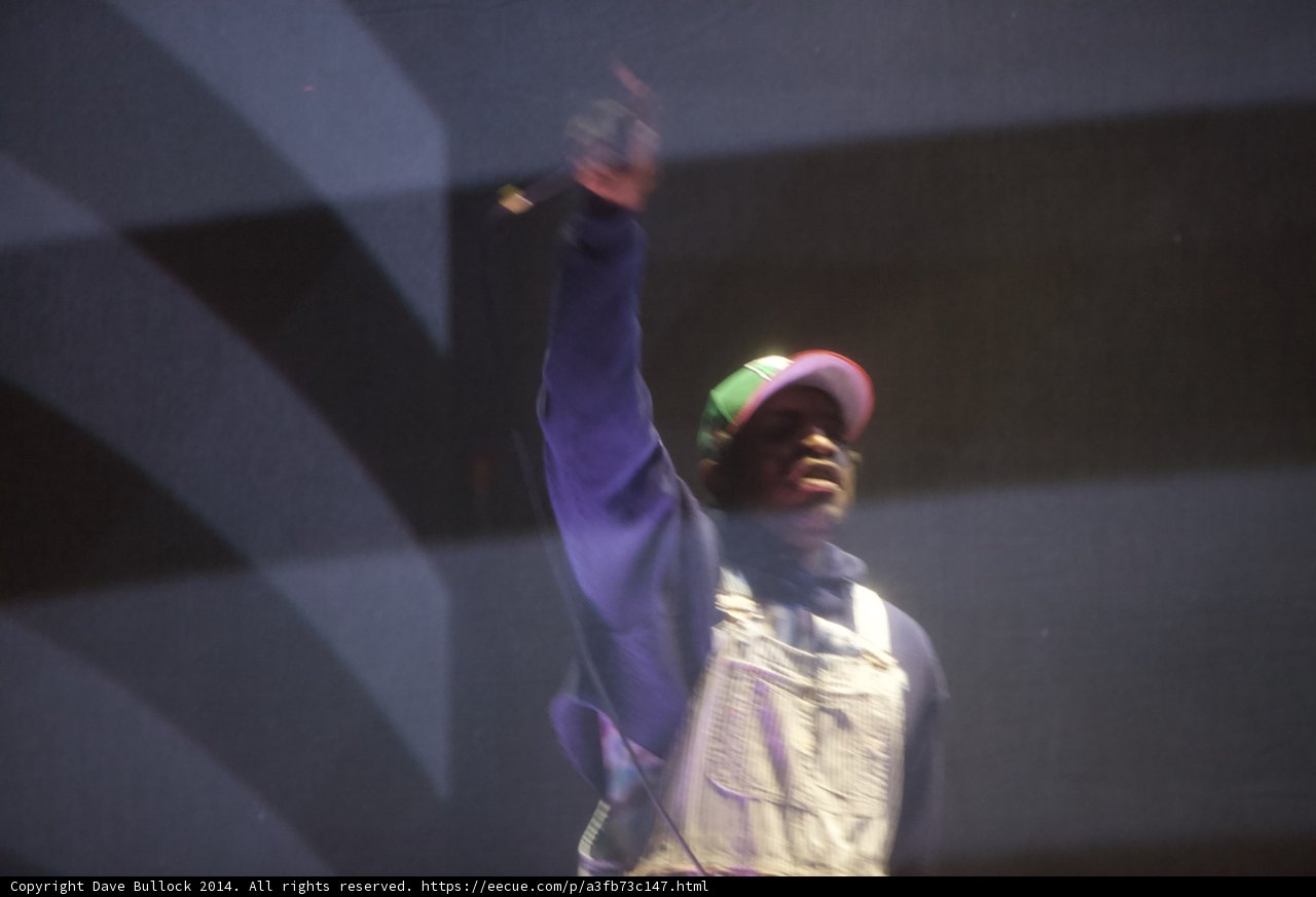 Man in Overalls and Hat Center Stage