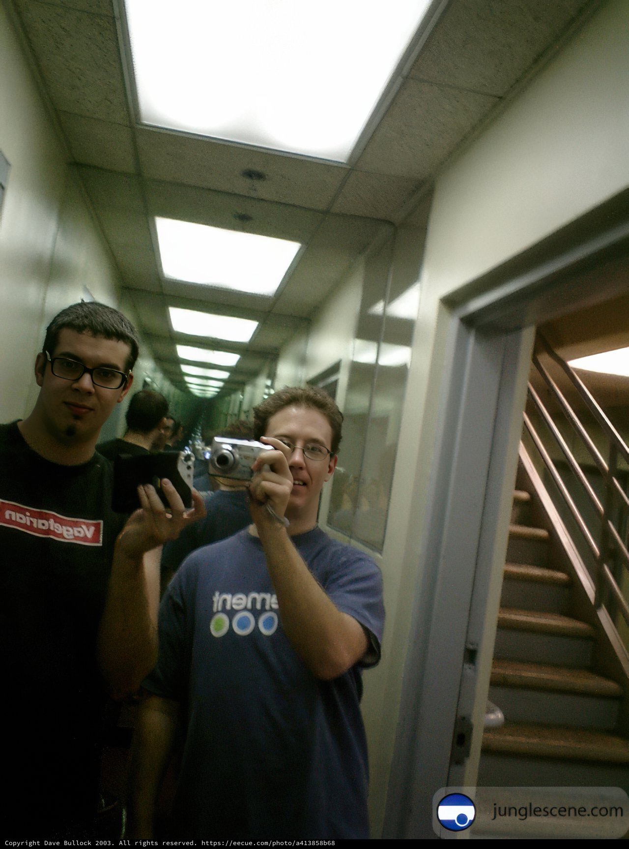 Two Men With A Camera On The Stairs