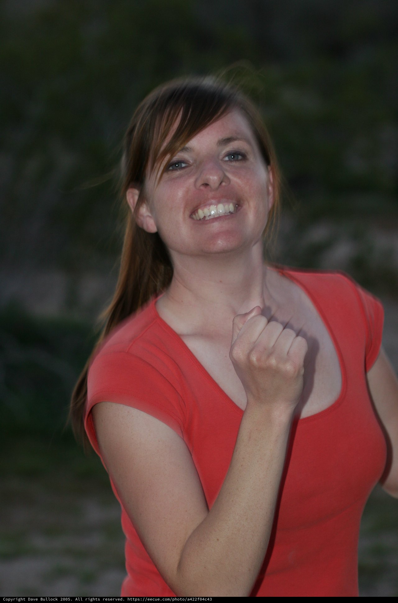 Joyful Woman in Red Celebrates Triumphant Moment