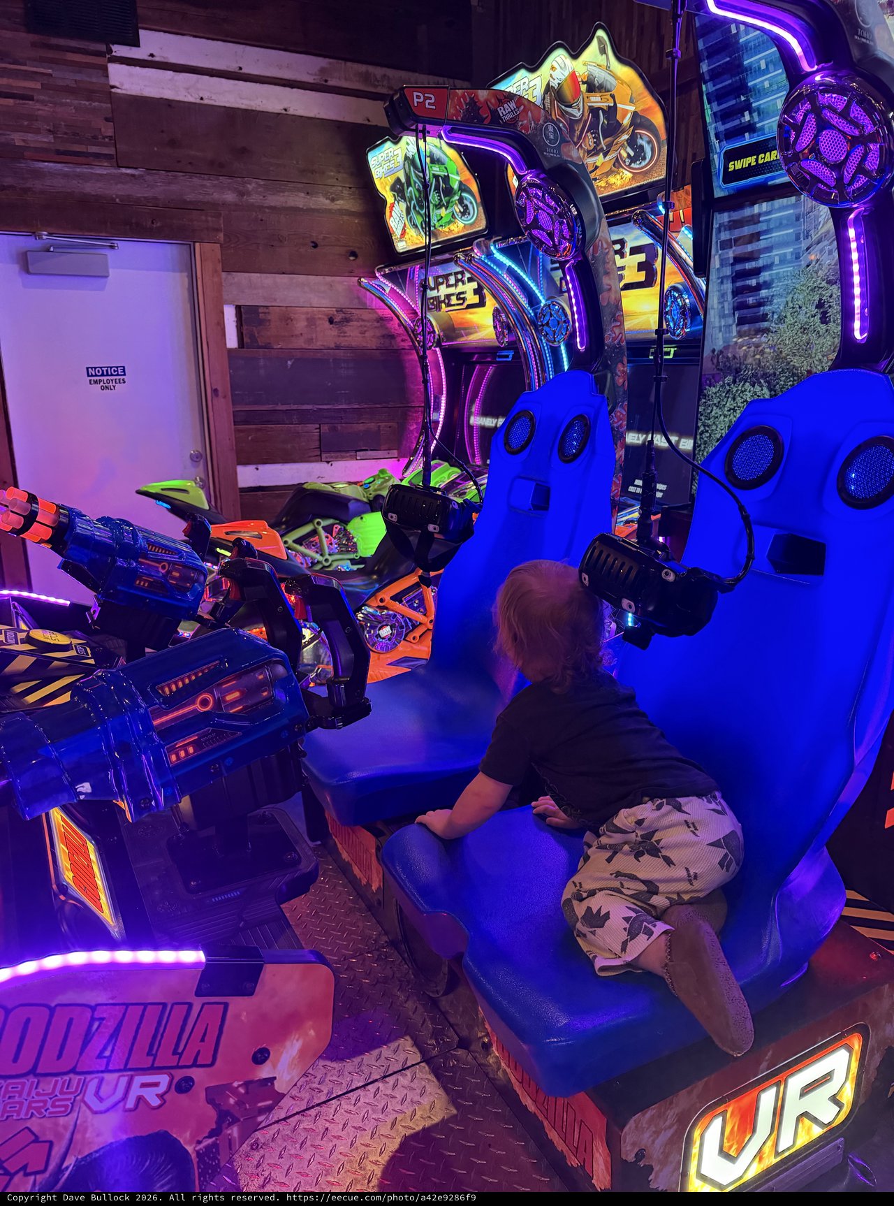 Gamer Playing Virtual Reality Motorcycle Arcade Game