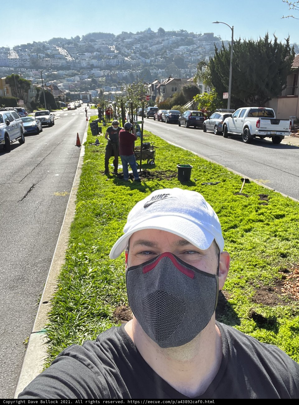 Man in Face Mask Walking Down Urban Street