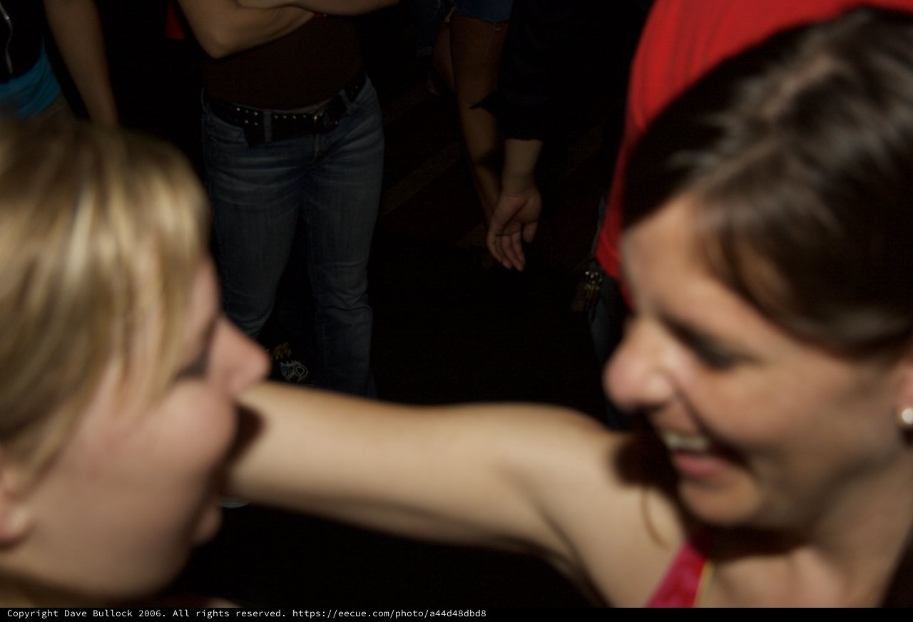 Two Women Laughing Together at a Nightclub Party
