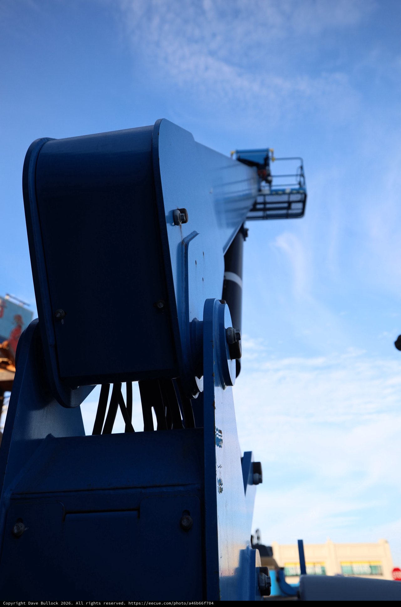 Blue Aerial Lift Platform Against Clear Sky