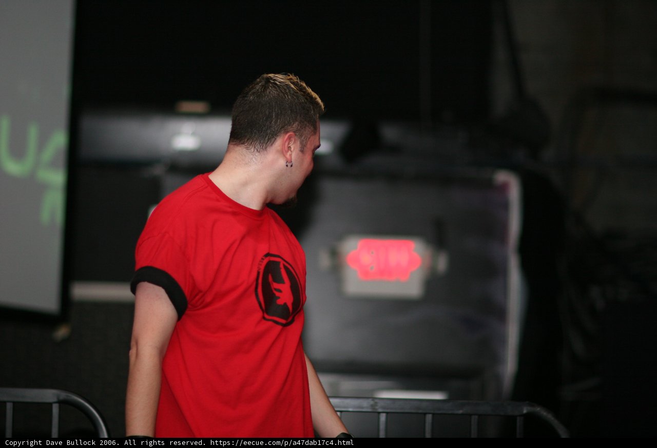 Man in a Red Shirt Working on a Laptop