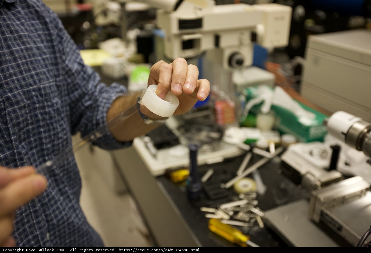 Scientist holding white object in laboratory