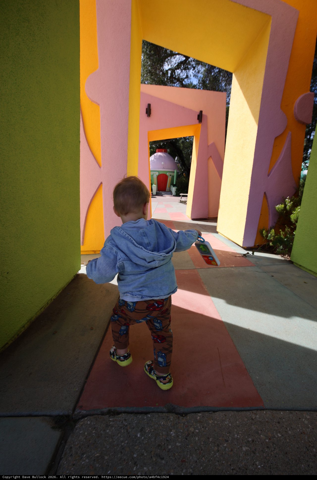 Child Exploring Colorful Architectural Play Structure