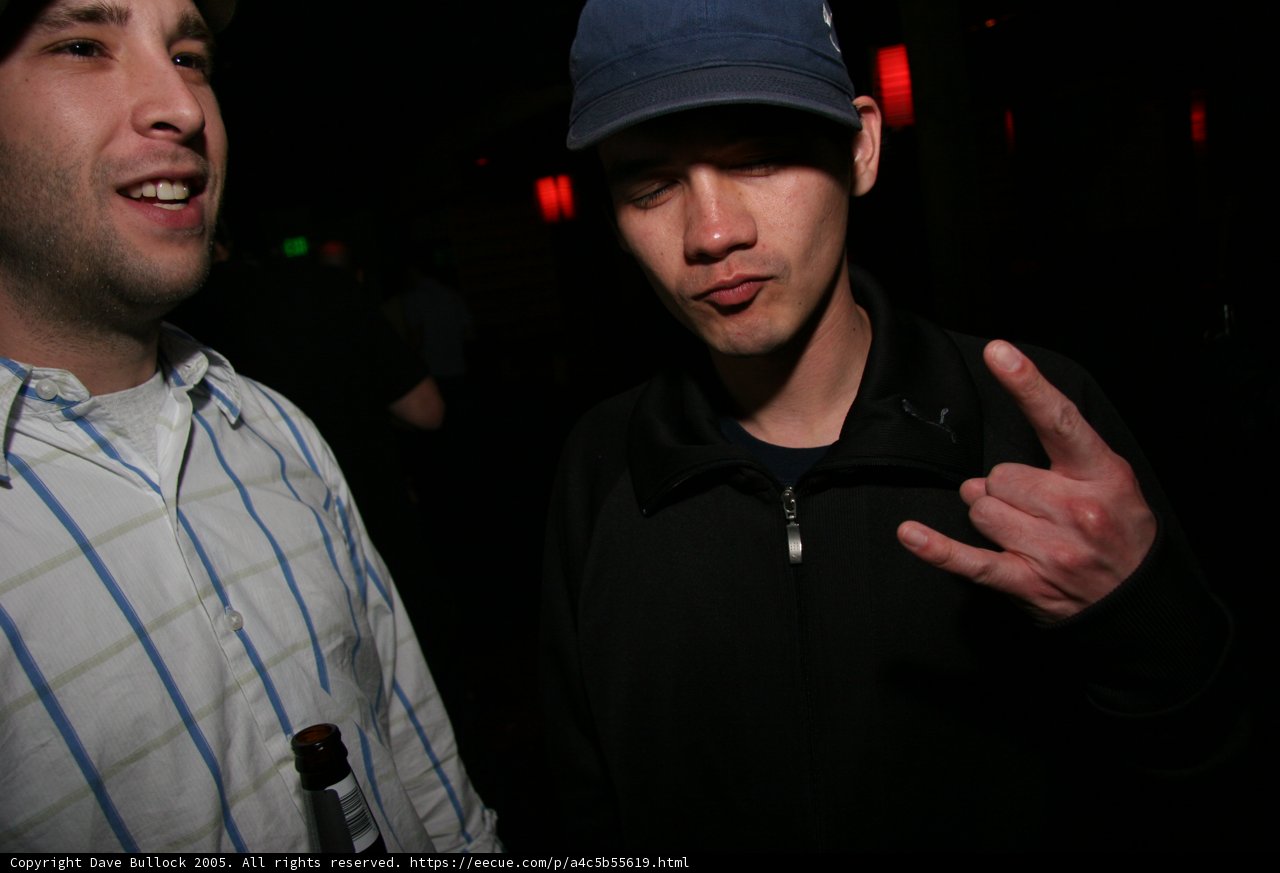 Men making peace sign in club
