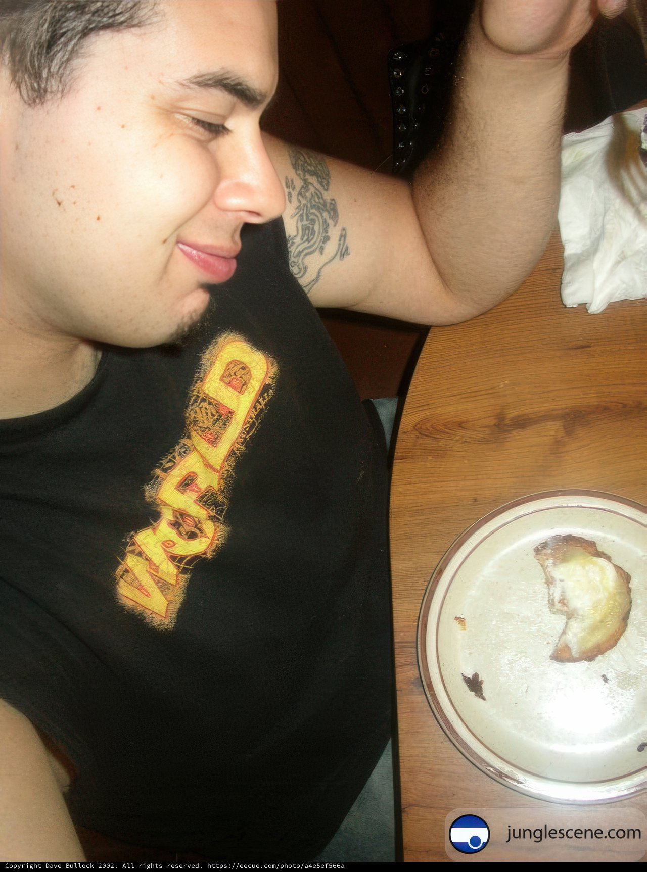 Tattooed Man Enjoying a Meal