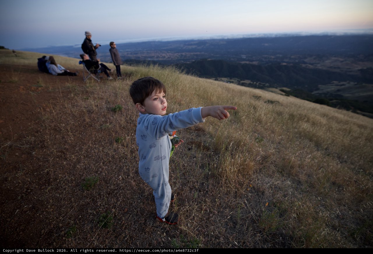 Young Explorer Points Toward the Valley Below
