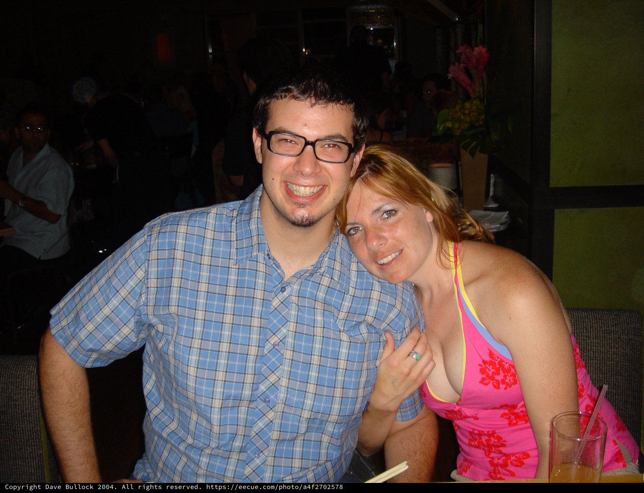 Couple Smiling Together at a Dimly Lit Restaurant