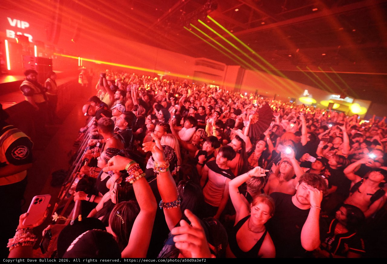Massive Crowd Erupts Under Red Laser Light Show