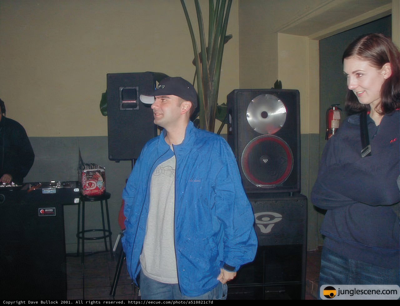 Two Music Enthusiasts Pose for a Candid Shot Amongst Electronics and Greenery