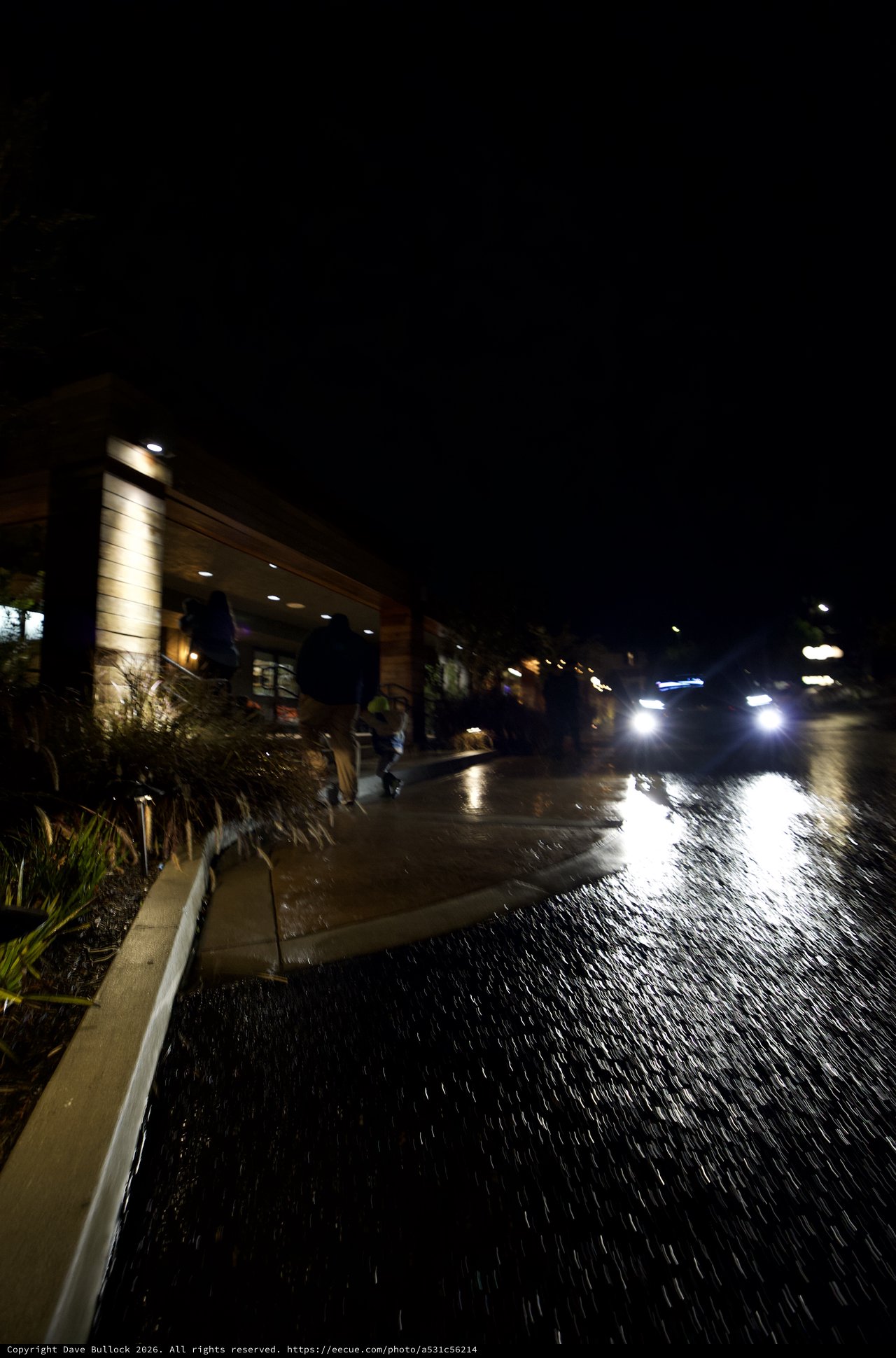 Emergency Vehicle Navigating Flooded Street at Night