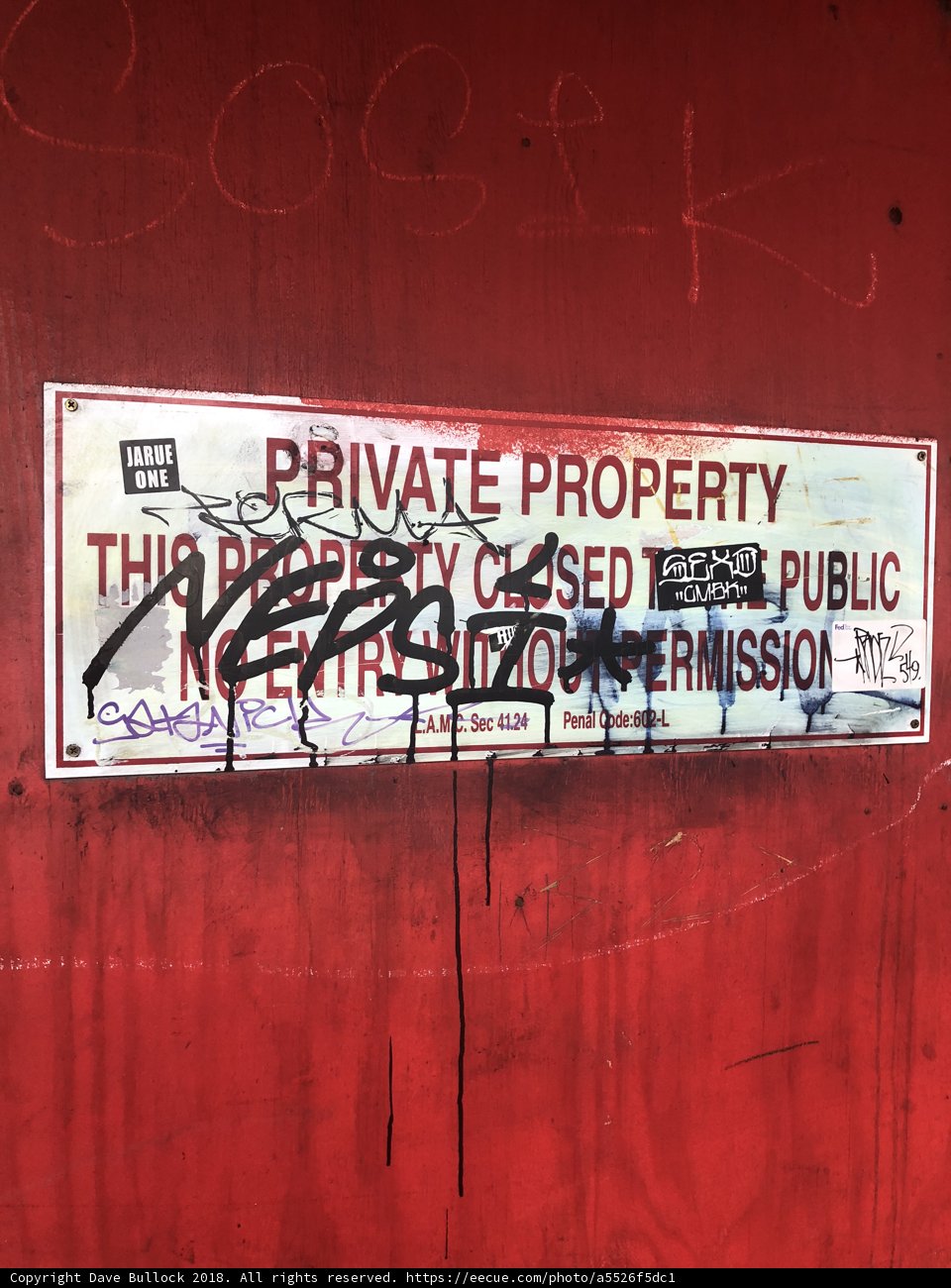 Defaced Red Sign