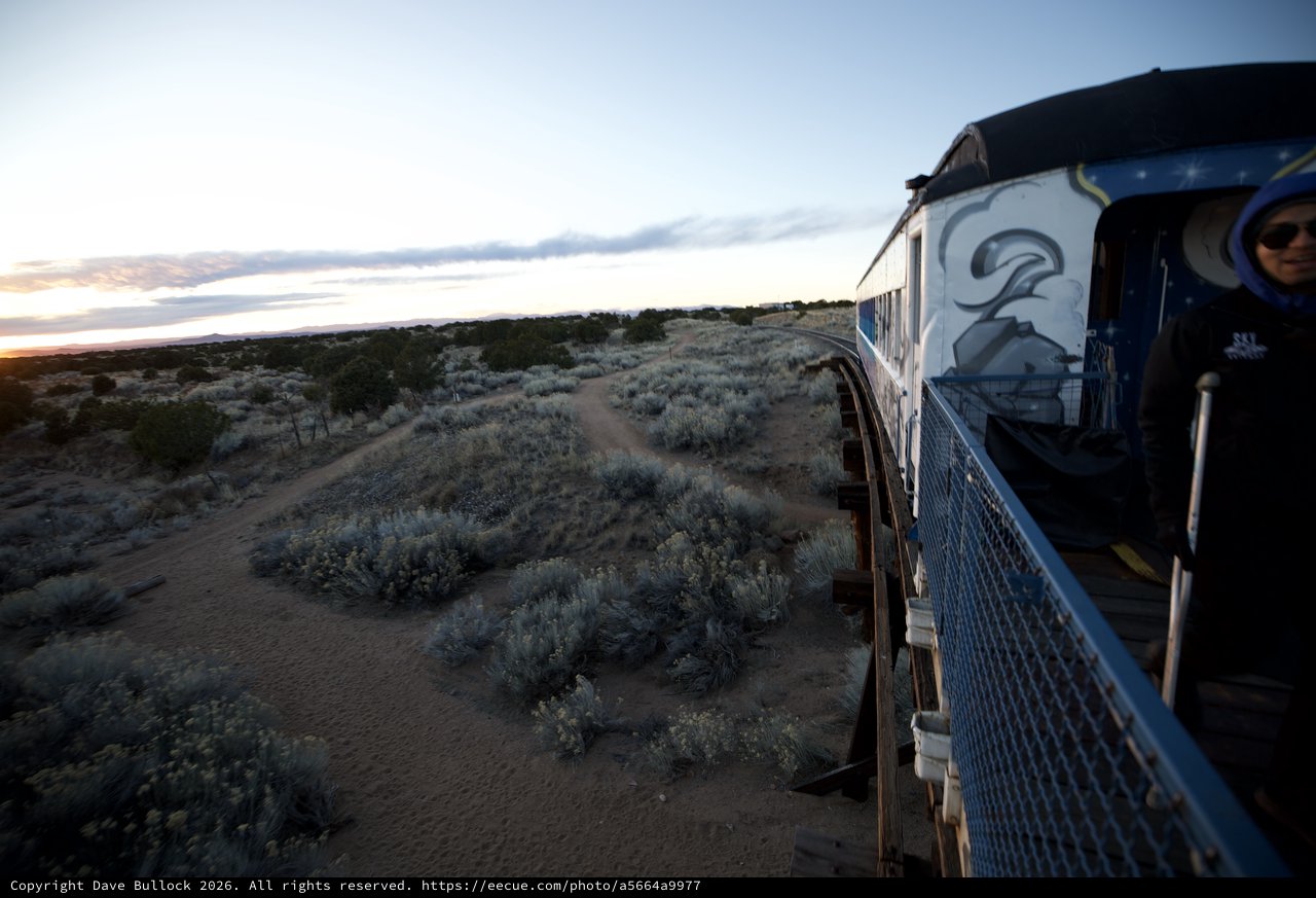 Sunset Train Journey Through Desert Landscape