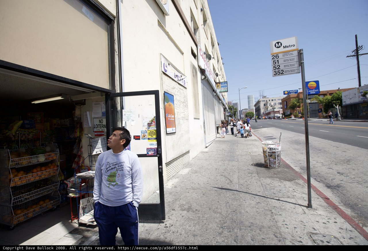 Man Standing in Front of the City Store