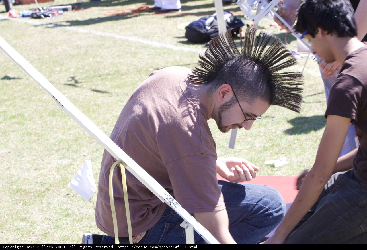 Mohawk Man Poses with Sword Outdoors