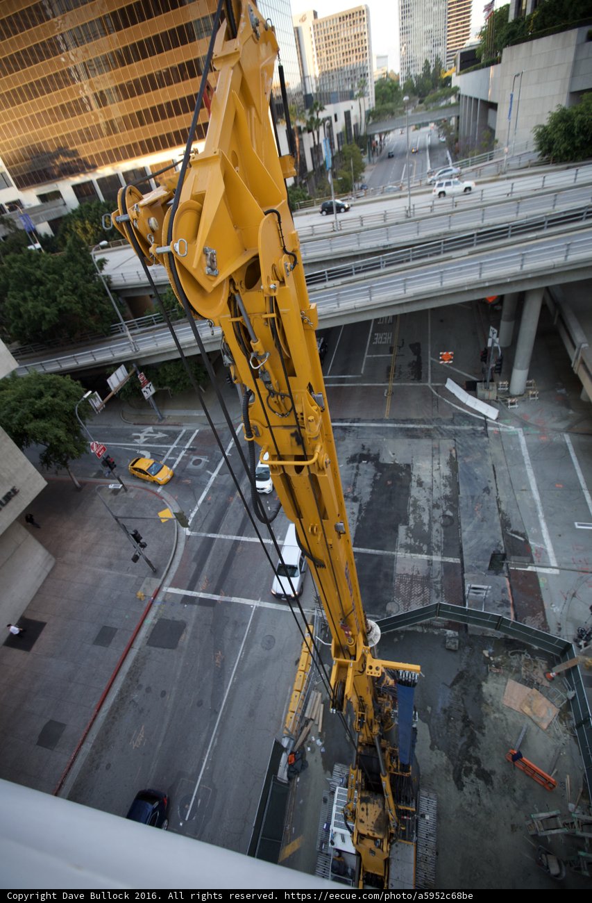 Yellow Construction Crane Sitting on Building
