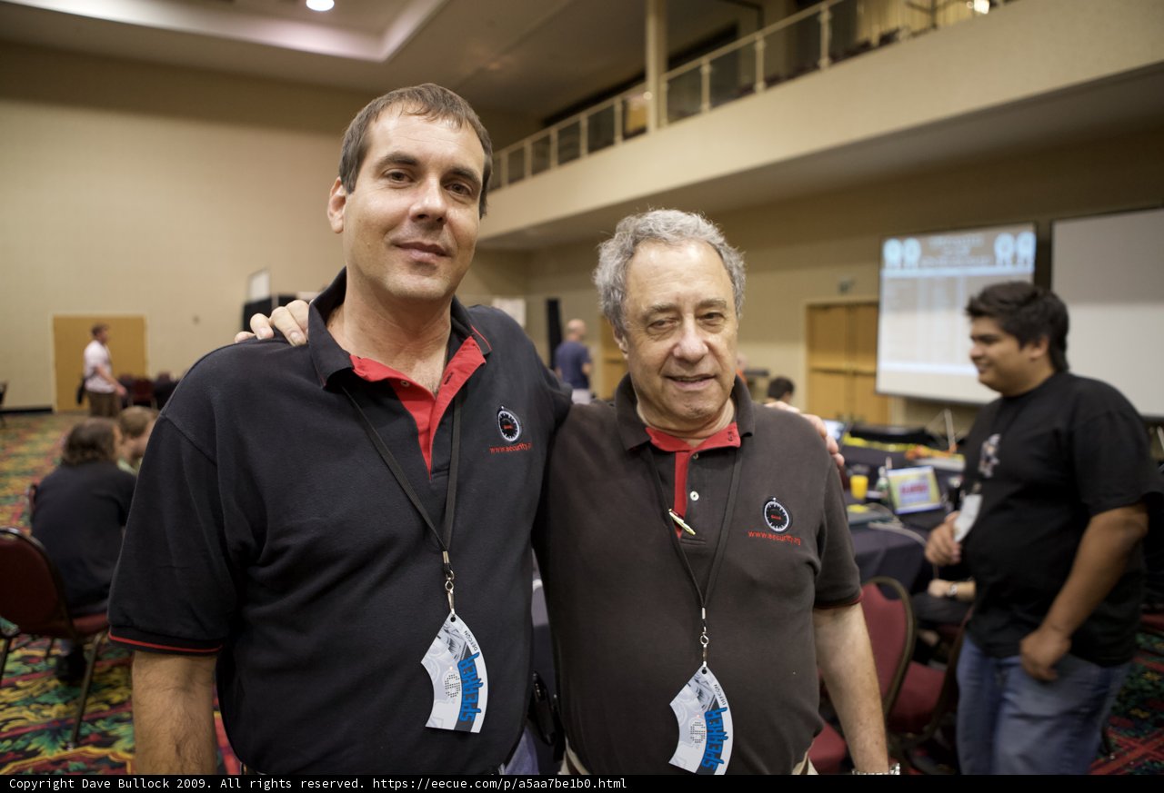 Two Men in Black Shirts and Red Ties