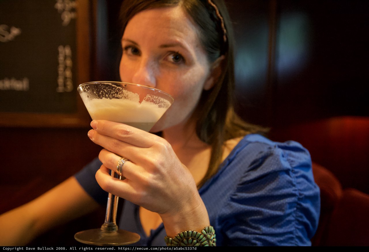 Woman Savoring a Cocktail at Upscale Bar
