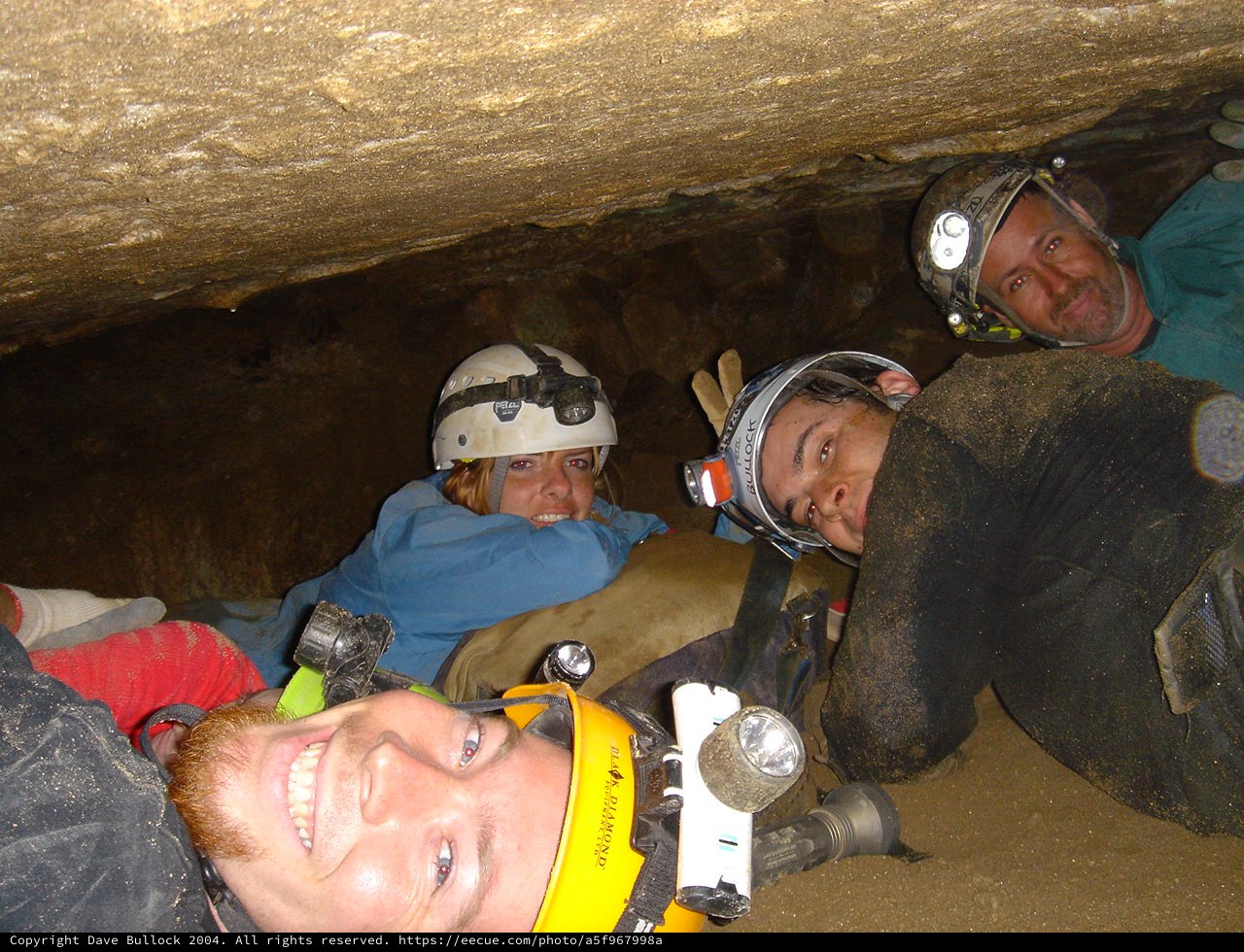 Cavers Squeeze Through Tight Underground Passage Together